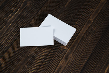 Blank business cards on wooden working table with copy space for add text ID. and logo, business company concept.