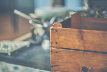 Vintage home decor: old wooden box for a kitchenware on the kitchen background. Idea of using industrial boxes in the interior of the kitchen.Selective focus. Free space for text.