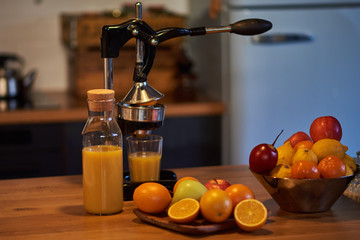 Fresh oranges. Cut oranges. Pressed orange manual method. Oranges and sliced oranges with juice and squeezer.