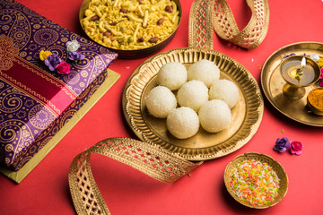 Raksha bandhan Festival : conceptual Rakhi made using plate full of Rasgulla sweet with band. A traditional Indian wrist band which is a symbol of love between Brothers and Sisters