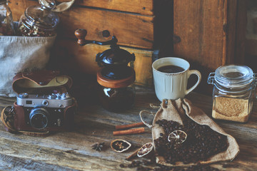 Cup of coffee latte and camera in coffee shop vintage color.