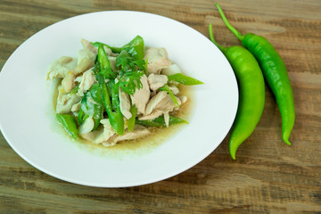 Stir Fried Chicken with green pepper on wood background, Thai food