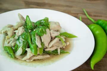 Stir Fried Chicken with green pepper on wood background, Thai food