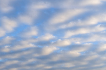 A blue cloudy sky. Background.
