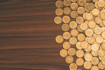 Stack of coin on wooden working table, business and finance concept.