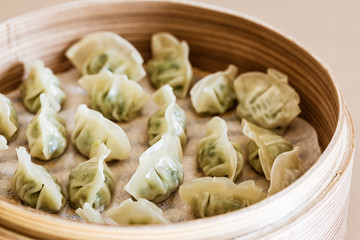 Asian gyoza, dumplings snack, chopsticks, steamer