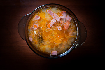 Appetizing soup Solyanka on a dark background