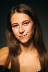 Fototapeta premium Portrait beautiful girl on a dark studio background
