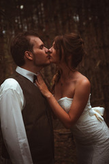 bride and groom in the forest of firs