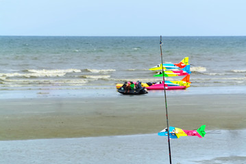 Colorful Toy Planes Made of Foam Hanging on the Beach