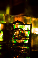 colored lighting of glasses in the night club bar