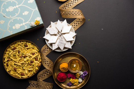 Raksha bandhan Festival greetings: conceptual Rakhi made using a plate full of Kaju Katli Barfi/Burfi and fancy band and pooja Thali. selective focus