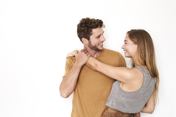 Laughing young couple in white studio