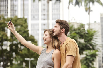 Obraz premium Happy couple selfie in city, brazil