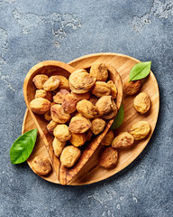 Sun dried apricots on gray concrete background. Top view.
