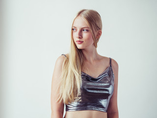Naklejka premium Blonde long hair woman girl in silver dress over white background