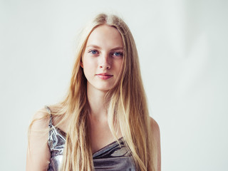 Blonde long hair woman girl in silver dress over white background