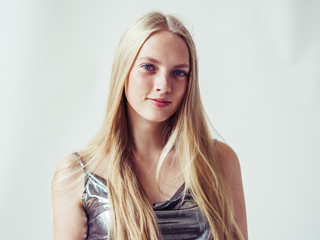 Blonde long hair woman girl in silver dress over white background