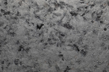 Handmade paper texture with recycled materials, tree leaves and cotton fibers. In delicate tones, ocher, light green and dark.