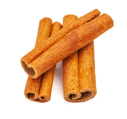 Several cinnamon sticks lined up insolated on white background