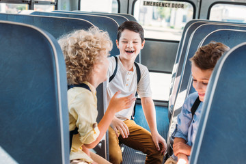 group of adorable schoolboys having fun together while riding on school bus © LIGHTFIELD STUDIOS