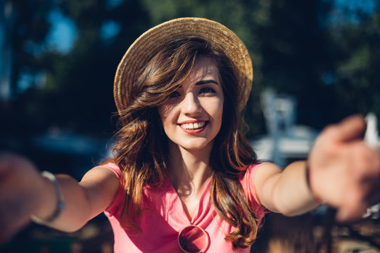 Close up portrait Nice laughing girl in hat making selfie on the beach.Cute summer fashion portrait of beauty brunette woman having fun