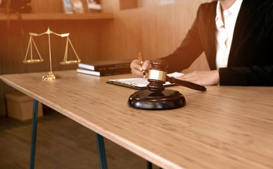 Legal counsel presents to the client a signed contract with gavel and legal law. justice and lawyer...