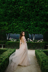 Portrait of a lovely young girl in a lush dress walking around the park and the Grand Palace(Brussels)