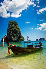 Wooden boat standing at the beach of Krabi in Thailand