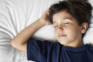 Obraz na płótnie Canvas Little boy sleeping in bed