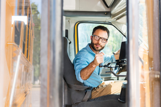 School Bus Driver Losing Door With Lever And Looking Back