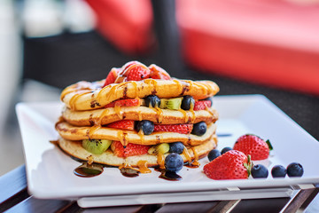 stack of pancakes with strawberry and blueberry