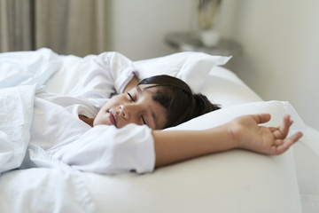 Tired out boy fast asleep in bed