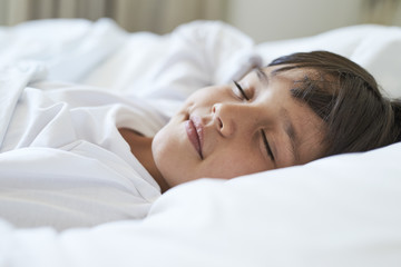 Fototapeta na wymiar Sleeping boy in bed, close up