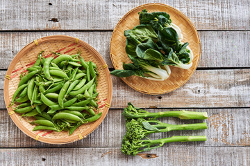 Green peas, Broccoli ,Chinese cabbage on wicker plates.