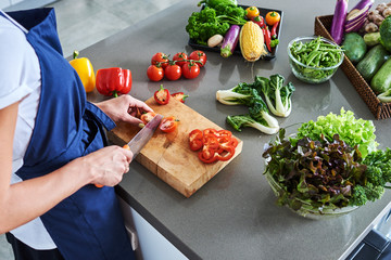 Chef cutting fresh and delicious vegetables for cooking.