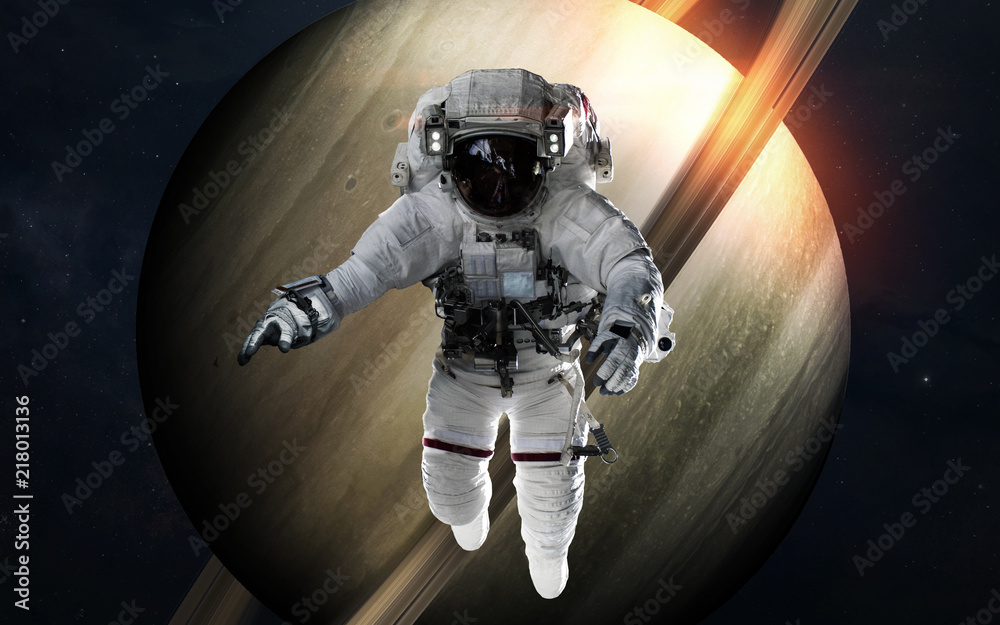 Wall mural saturn with astronaut in front of planet. solar system. elements of this image furnished by nasa