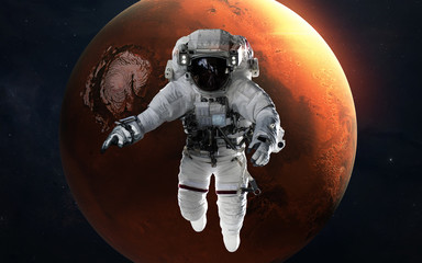 Mars with astronaut in front of planet. Solar system. Elements of this image furnished by NASA