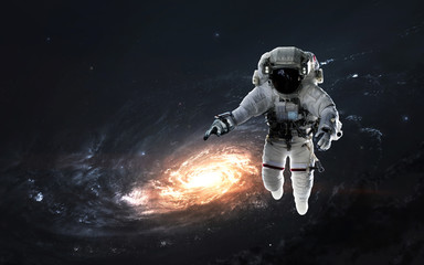 Obraz na płótnie Canvas Astronaut at spacewalk, EVA, awesome science fiction wallpaper. Elements of this image furnished by NASA
