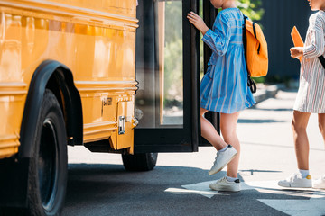 cropped shot of schoolgirls entering school bus © LIGHTFIELD STUDIOS