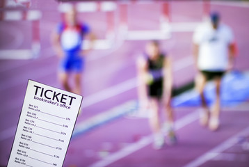 Bookmaker ticket on the background of the TV, which shows athletics, running, jumping, sports betting, Bookmaker ticket