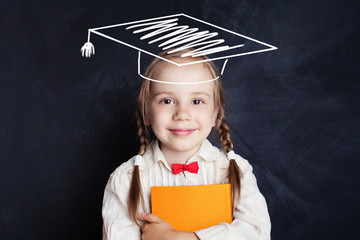 School child with education book and graduation hat on blackboard banner background