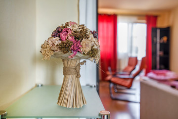 Dried bouquet of flowers and grain used as modern floristics interior design element in a hallway.