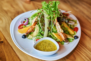 Salad with shrimps or prawn and arugula.