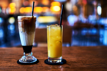 Glasses with orange juice and  coffee frappe.
