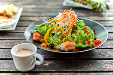 Healthy vegetables salad with grilled salmon.