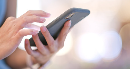 Woman working on cellphone inside shopping mall