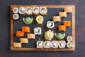 Big set of rolls served on stone plate. Top view.