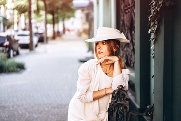 Woman in white vintage dress walking on the street