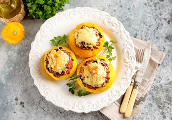 Organic yellow patissons stuffed with meat, onions, carrots, mushrooms and red pepper baked in the oven with cheese.